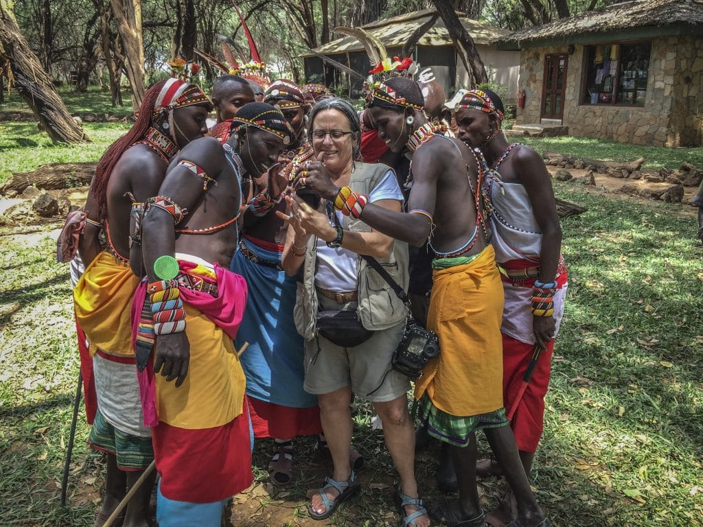 Samburu people look at a photo on a phone