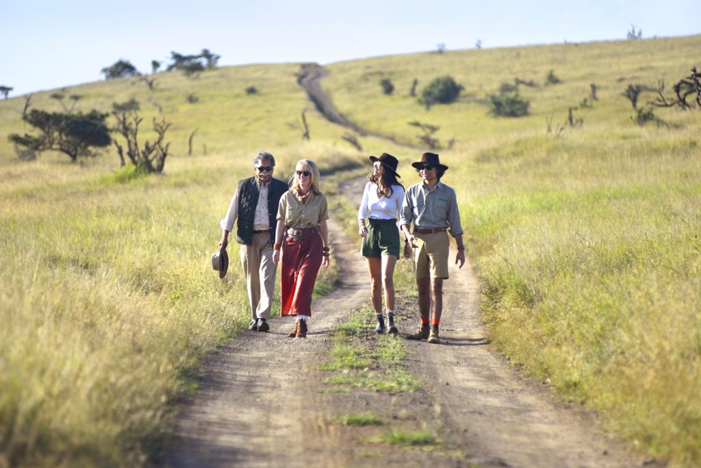 The Pinto family walks on a path through a field