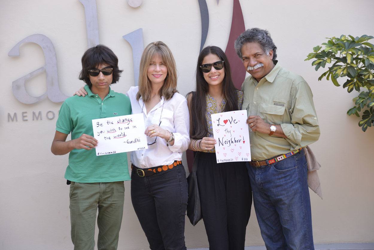 Pinto family pose with signs