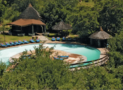 Panned out image of the Taragire Sopa Lodge - Micato Safari - showing a large pool.