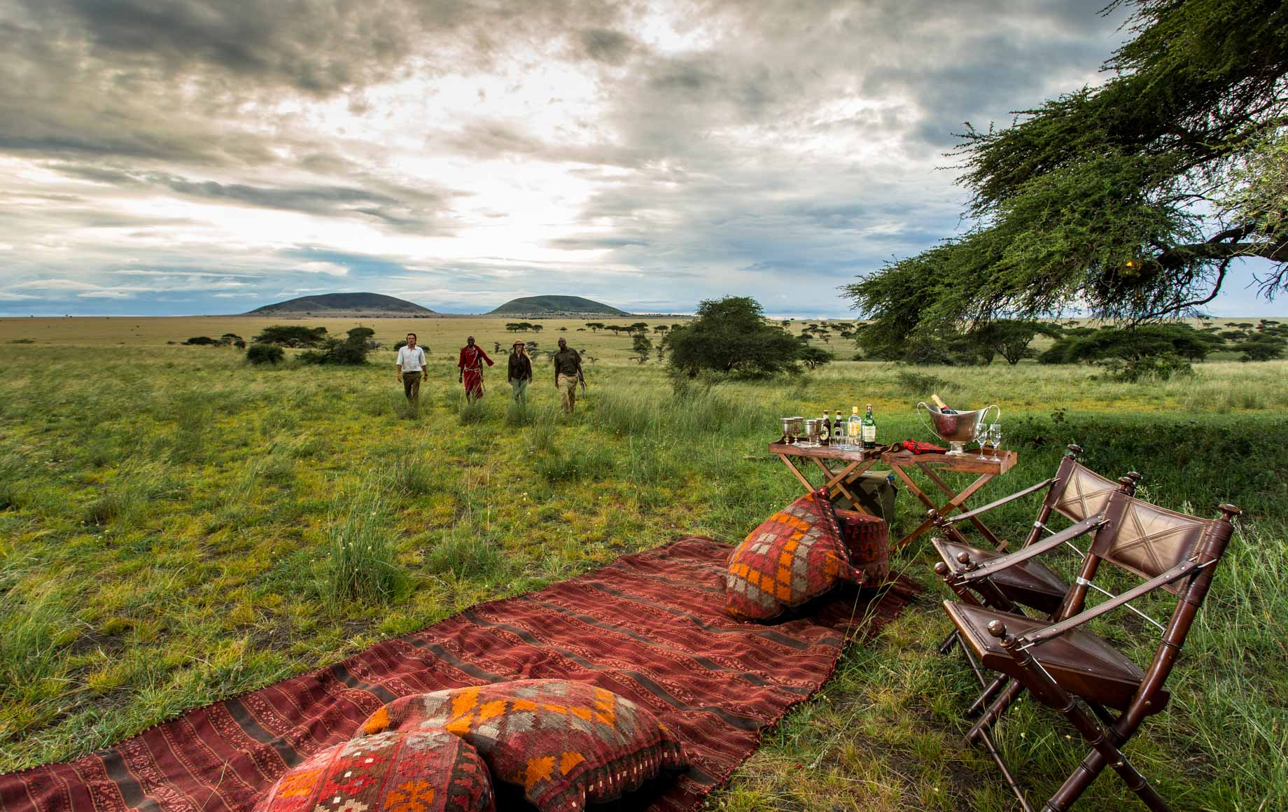 Tourists walking back to picnic from nature stroll at Chyulu Hills in Africa