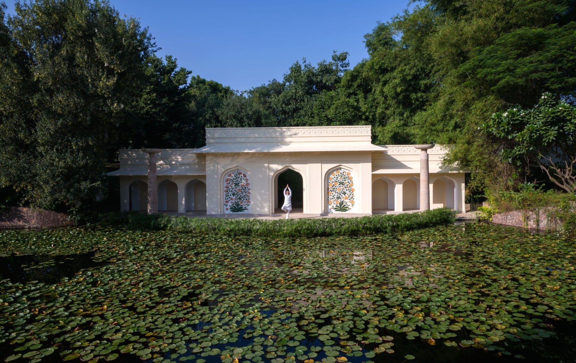 a white house with a lake