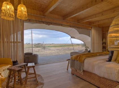 A bedroom looking out into the safari