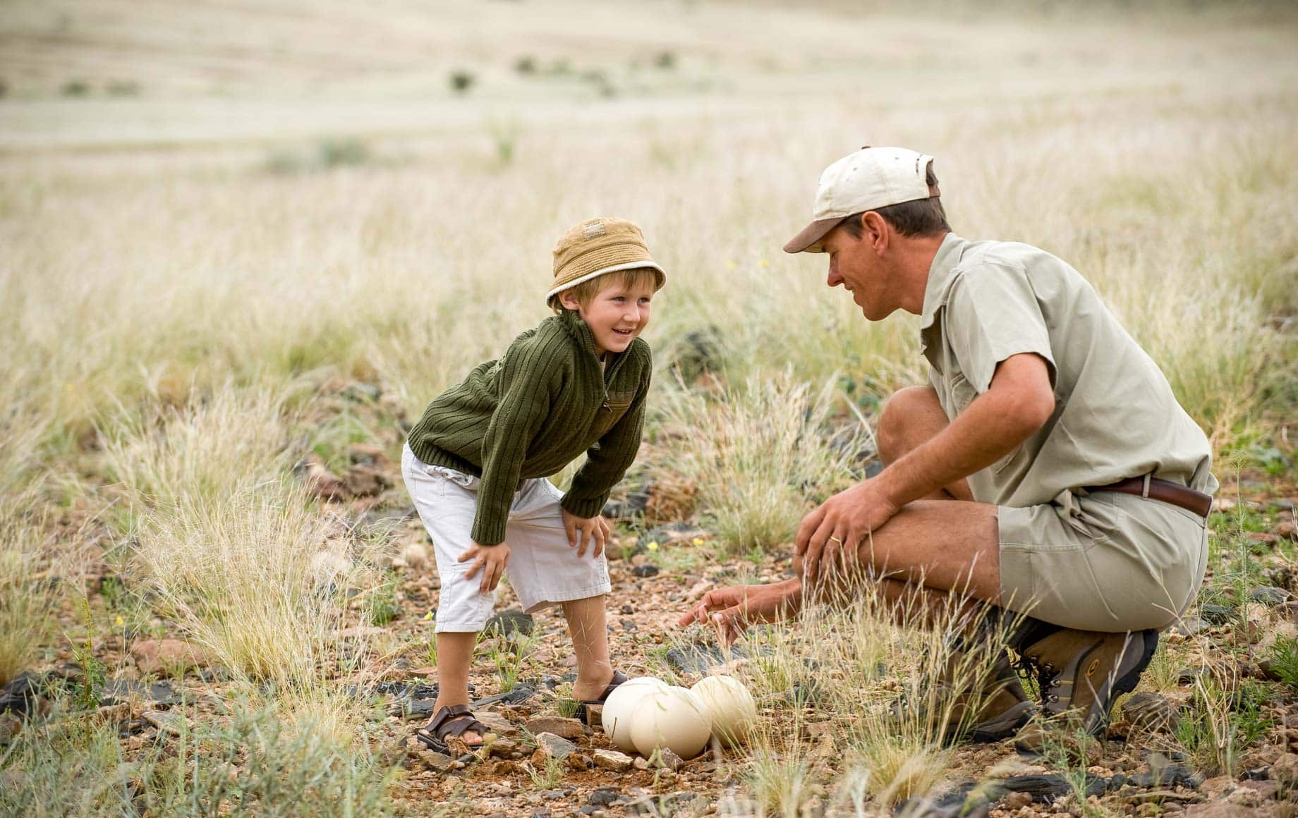 Curious boy happily chatting with a man at Sossusvlei Namib Desert
