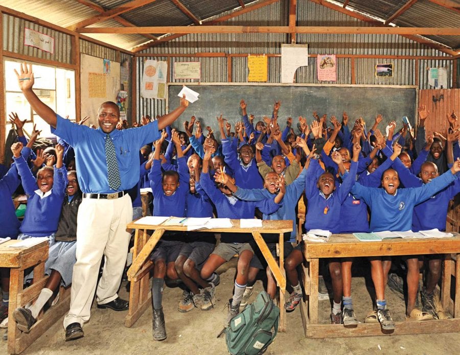 Happy students and teacher in a school in Africa