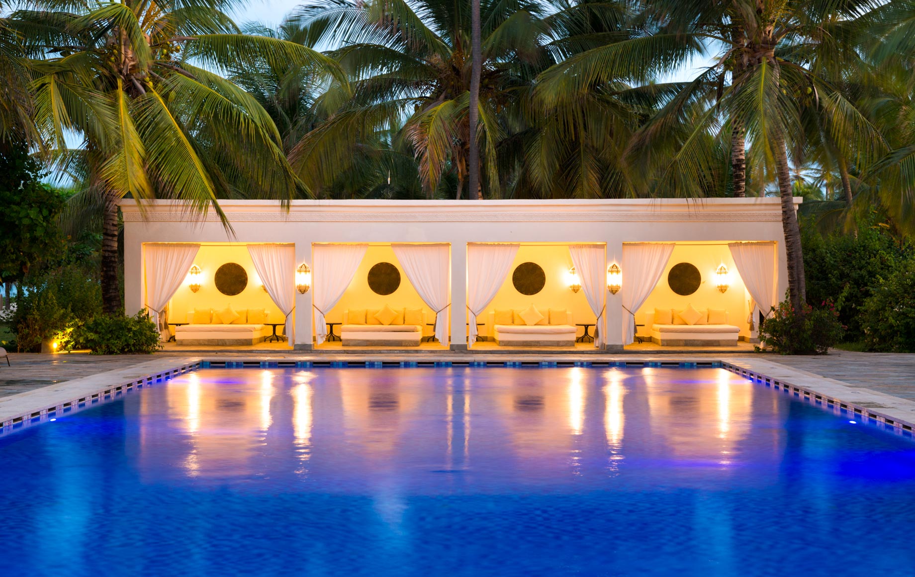 Outdoor pool of Baraza Resort & Spa at dusk