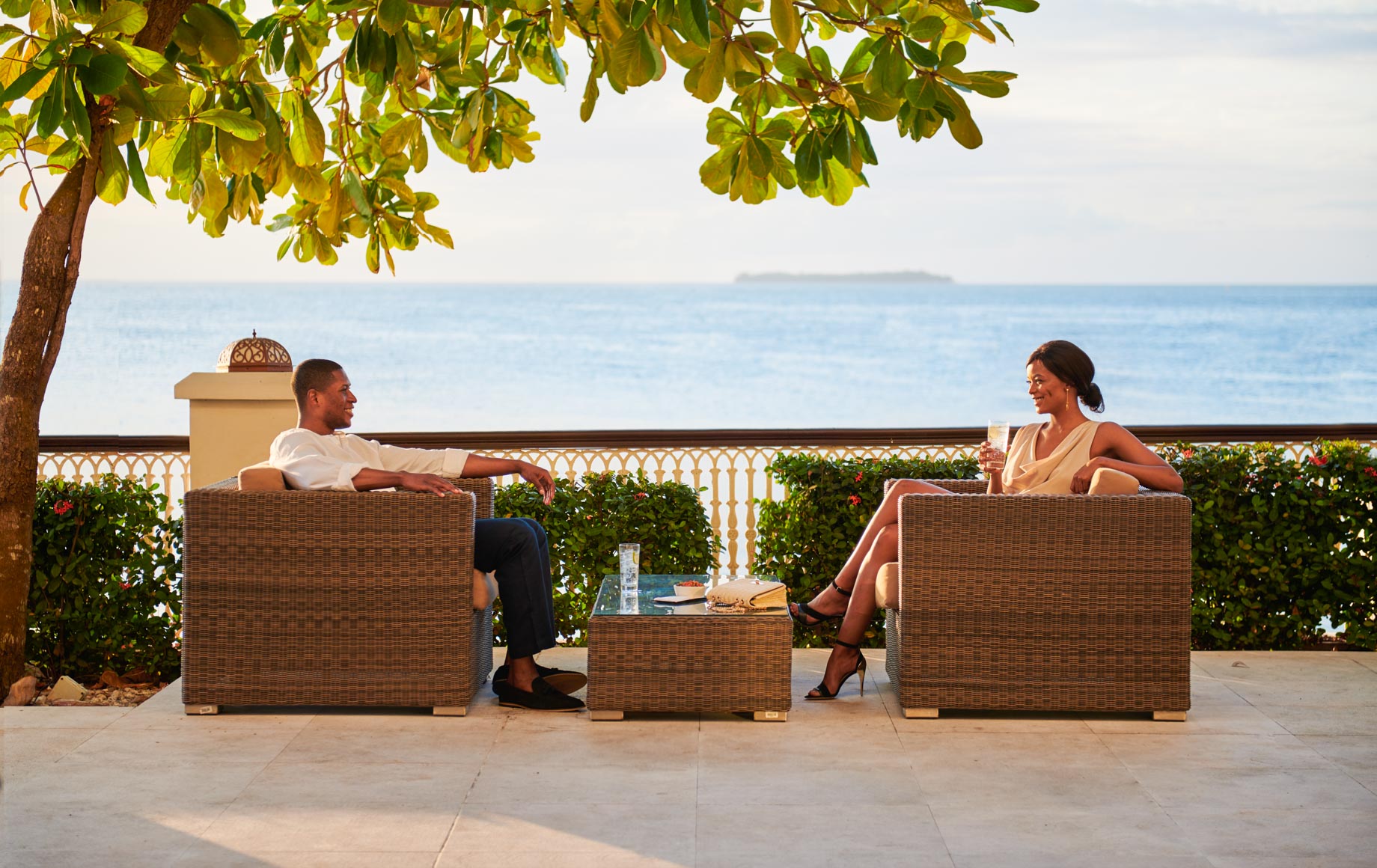 Couple has drinks on deck at Park Hyatt, Zanzibar