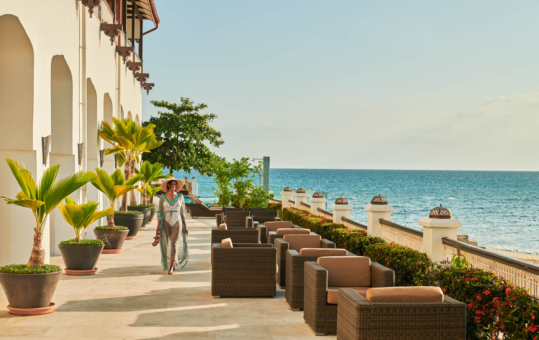 Woman walks along deck of Park Hyatt, Zanzibar