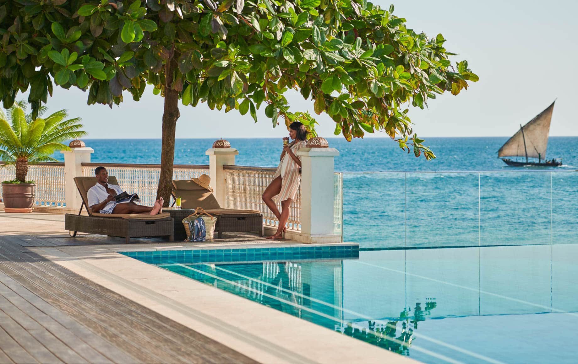 Woman stands near pool at Park Hyatt, Zanzibar