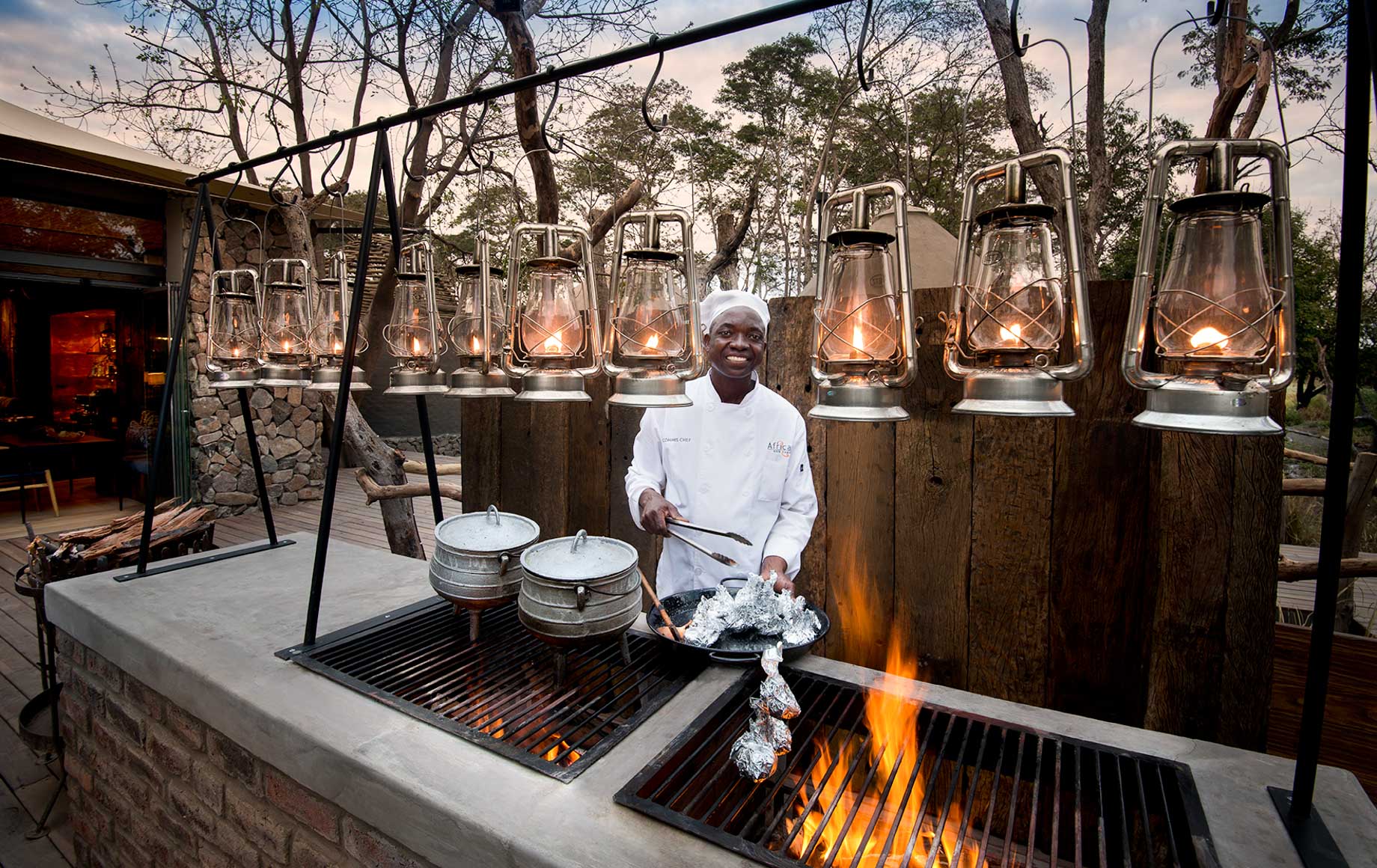 Chef cooks on outdoor grill at Thorntree River Lodge