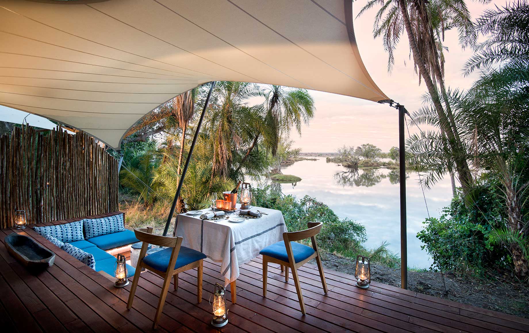 Table and lounge area on deck of Thorntree River Lodge