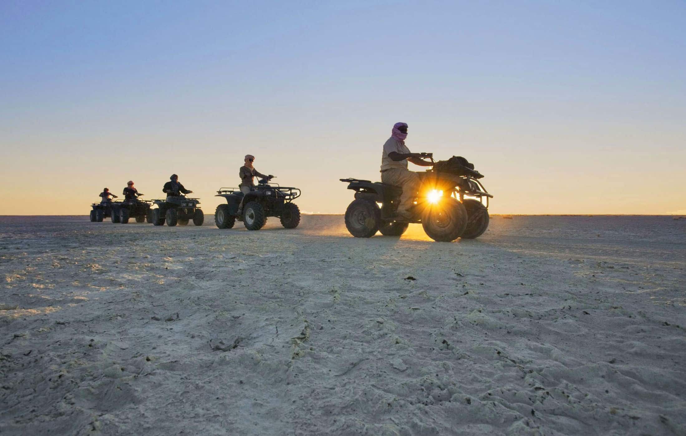 a group of tourists on atvs