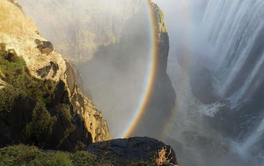 a rainbow in a waterfall