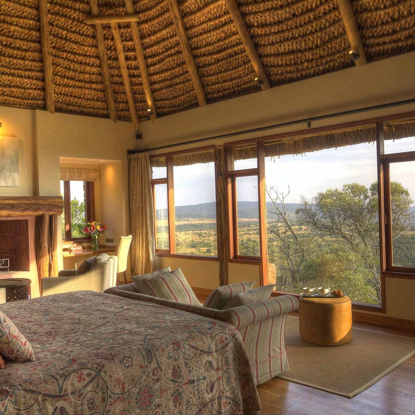 a bedroom at Laragai House with a large window overlooking the plains