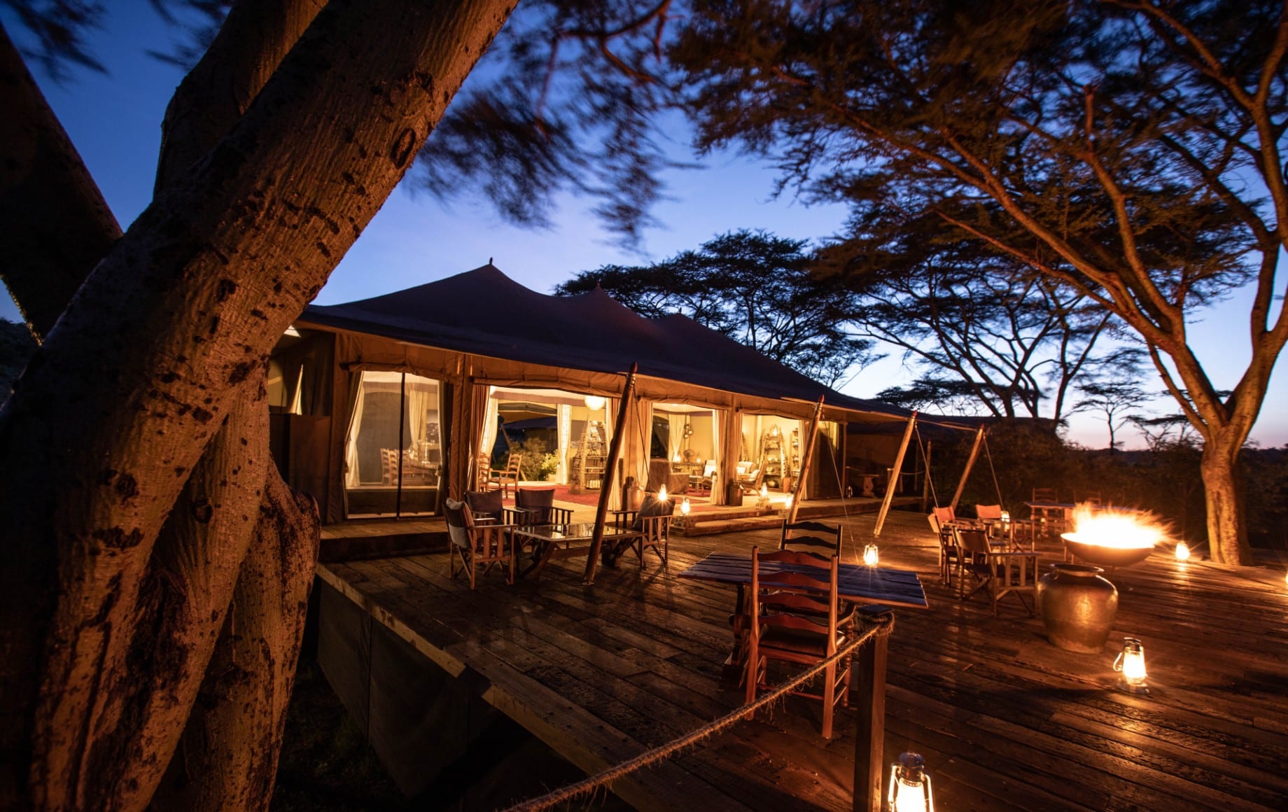 the deck outside of a room at Mara Nyika at night