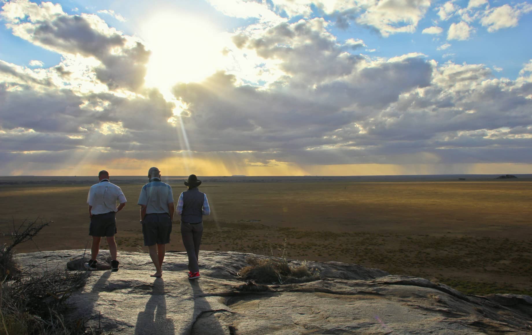 Three people looking out over the Serengetti