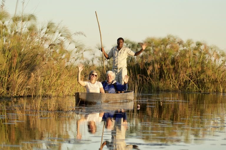 a couple on a mokoro ride with their Safari Director
