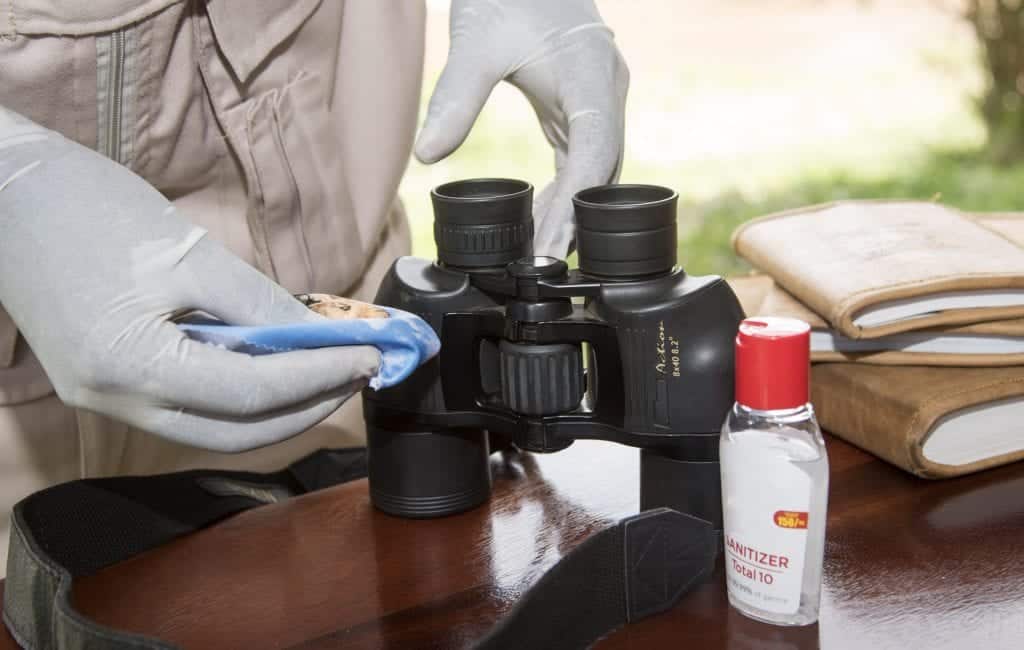Micato Safari Director sanitizes binoculars