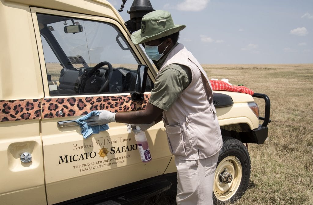 Micato Safari Director sanitizes vehicle