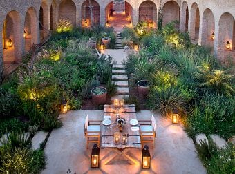 Table set for dinner outside lit by candles