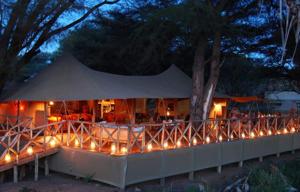 The Elephant Bedroom Camp lit at night by candles.