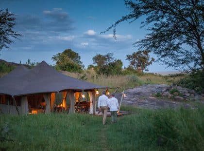 A couple walking back to the Serengeti Pioneer Camp.